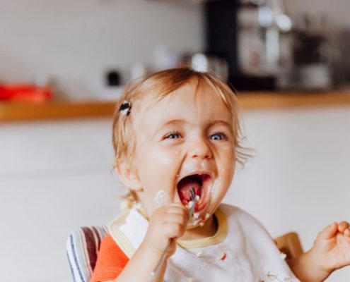 Baby eating in a high chair